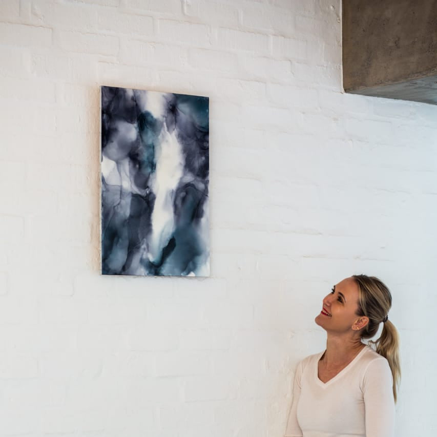 Woman looking at abstract art on a white wall